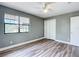 Bedroom with laminate flooring, closet, neutral paint, and natural light from a window at 713 W 3Rd St, Lakeland, FL 33805