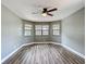 Bright bedroom boasts updated flooring, ceiling fan, and large windows at 713 W 3Rd St, Lakeland, FL 33805