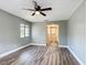 Inviting bedroom with modern flooring, ceiling fan, and convenient access to the bathroom at 713 W 3Rd St, Lakeland, FL 33805