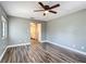Comfortable bedroom features updated flooring, ceiling fan, and adjacent bathroom access at 713 W 3Rd St, Lakeland, FL 33805
