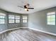 Spacious bedroom with updated flooring, ceiling fan, and lots of natural light at 713 W 3Rd St, Lakeland, FL 33805