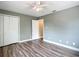 Bedroom featuring laminate flooring, closet, neutral paint, and a ceiling fan at 713 W 3Rd St, Lakeland, FL 33805