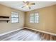 Cozy bedroom featuring modern ceiling fan, laminate flooring, neutral paint, and windows at 713 W 3Rd St, Lakeland, FL 33805