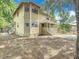 Charming home nestled amidst trees, featuring a covered porch and sidewalks at 713 W 3Rd St, Lakeland, FL 33805