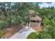Scenic side view of a two-story home with lush landscaping and a paved walkway at 713 W 3Rd St, Lakeland, FL 33805