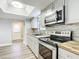 Modern kitchen with stainless steel appliances, stylish backsplash, and wood countertops at 713 W 3Rd St, Lakeland, FL 33805