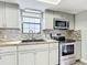 Well-lit kitchen featuring stainless steel appliances, and neutral cabinets at 713 W 3Rd St, Lakeland, FL 33805