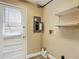 Functional laundry room area with a door to the outside and utility shelves at 713 W 3Rd St, Lakeland, FL 33805