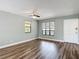 Bright living room with hardwood floors, ceiling fan, and natural light from two windows at 713 W 3Rd St, Lakeland, FL 33805