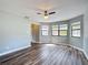 Spacious living room boasting laminate flooring, large windows and neutral paint at 713 W 3Rd St, Lakeland, FL 33805