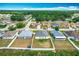 A high aerial view shows the neighborhood, highlighting the neatly arranged homes and green spaces at 1639 Saddlehorn Dr, Lakeland, FL 33810