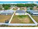 Aerial view of the backyard, enclosed with a white vinyl fence and an added trampoline at 1639 Saddlehorn Dr, Lakeland, FL 33810