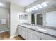 Bathroom featuring double sinks, granite countertops, and a bathtub-shower combo at 1639 Saddlehorn Dr, Lakeland, FL 33810