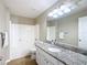 Bathroom featuring granite countertops, modern vanity lights, and a shower-tub combo at 1639 Saddlehorn Dr, Lakeland, FL 33810