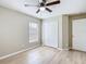 Bright bedroom with wood-look floors, ceiling fan, and closet with bi-fold doors at 1639 Saddlehorn Dr, Lakeland, FL 33810