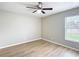 Bright bedroom with wood-look floors, ceiling fan, and natural light from the window at 1639 Saddlehorn Dr, Lakeland, FL 33810