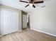 Bedroom featuring wood-look floors and large closet with bi-fold doors at 1639 Saddlehorn Dr, Lakeland, FL 33810