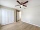 Bright bedroom with a ceiling fan, light walls, and a view into the hallway at 1639 Saddlehorn Dr, Lakeland, FL 33810