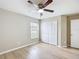Clean and simple bedroom featuring a ceiling fan, natural light from the window, and ample closet space at 1639 Saddlehorn Dr, Lakeland, FL 33810