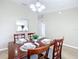 Charming dining room with wood table set for four, illuminated by a stylish chandelier at 1639 Saddlehorn Dr, Lakeland, FL 33810