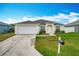 Charming single-story home with a well-manicured lawn and a two-car garage at 1639 Saddlehorn Dr, Lakeland, FL 33810