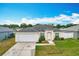 Well-maintained single-story home featuring a two-car garage and a landscaped front yard at 1639 Saddlehorn Dr, Lakeland, FL 33810
