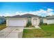 Charming single-story home with a well-manicured lawn and a two-car garage at 1639 Saddlehorn Dr, Lakeland, FL 33810