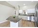 Bright and airy kitchen featuring stainless steel appliances and a granite-topped island at 1639 Saddlehorn Dr, Lakeland, FL 33810