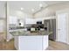 Spacious kitchen island with granite countertop, stainless steel appliances, and white cabinetry in a well-lit area at 1639 Saddlehorn Dr, Lakeland, FL 33810