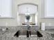 Stylish kitchen sink with granite countertops offering a view into the dining area at 1639 Saddlehorn Dr, Lakeland, FL 33810
