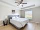 Main bedroom featuring wood-look floors, tray ceiling, and natural light from the window at 1639 Saddlehorn Dr, Lakeland, FL 33810