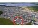 A panoramic aerial view of a residential community situated near a lake, highlighting the property's location at 3205 Royal Tern Dr, Winter Haven, FL 33881
