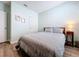 This bedroom features a wood frame bed with gray striped bedding and wood laminate flooring at 3205 Royal Tern Dr, Winter Haven, FL 33881
