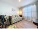 Bright bedroom with a trundle daybed, rocking chair, and wood flooring at 3205 Royal Tern Dr, Winter Haven, FL 33881