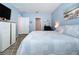 A well-lit bedroom boasts of a comfortable bed, neutral walls, and wood look flooring at 3205 Royal Tern Dr, Winter Haven, FL 33881