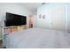 A bedroom featuring a TV with shelving, and wood laminate flooring at 3205 Royal Tern Dr, Winter Haven, FL 33881