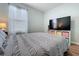 This bedroom features a TV with shelving, and wood laminate flooring at 3205 Royal Tern Dr, Winter Haven, FL 33881