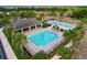 An aerial shot of the community pools with multiple lounge chairs at 3205 Royal Tern Dr, Winter Haven, FL 33881