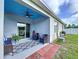 Cozy covered patio with comfortable seating, a ceiling fan, and sliding glass doors creating an inviting outdoor living space at 3205 Royal Tern Dr, Winter Haven, FL 33881