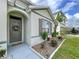Inviting front entrance with a decorative wreath, manicured landscaping, and a charming stone border enhancing the home's curb appeal at 3205 Royal Tern Dr, Winter Haven, FL 33881