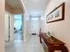 Bright and airy hallway with tiled floors, neutral paint, and a decorative console table creating a welcoming entry at 3205 Royal Tern Dr, Winter Haven, FL 33881