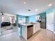 Bright, open-concept kitchen with stainless steel appliances and tiled floors flows into the living and dining areas at 3205 Royal Tern Dr, Winter Haven, FL 33881