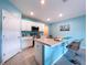 Modern kitchen boasts an island with seating, stainless appliances, and ample cabinet storage at 3205 Royal Tern Dr, Winter Haven, FL 33881