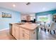 Stylish kitchen featuring an island, stainless steel dishwasher, and an adjacent dining area with a view at 3205 Royal Tern Dr, Winter Haven, FL 33881