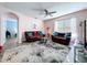Inviting living room featuring modern furnishings and an open layout with a beautiful area rug and ceiling fan at 3205 Royal Tern Dr, Winter Haven, FL 33881
