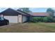 Charming single-story home featuring an attached garage and well-maintained landscaping at 9873 County Road 114B, Wildwood, FL 34785