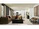 Cozy living room featuring a brown sectional sofa, modern decor, and an open view into the kitchen at 2751 Pioneer Trl, Eagle Lake, FL 33839