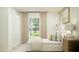Cozy bedroom with a soft bed, side tables, and a window overlooking the outdoor greenery at 2759 Pioneer Trl, Eagle Lake, FL 33839