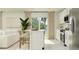 Modern kitchen showcases white cabinetry, stainless steel appliances, and an island, open to the living area at 2759 Pioneer Trl, Eagle Lake, FL 33839