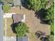 An aerial view of a home with a big fenced-in backyard and a large tree at 3360 Cross Fox Dr, Mulberry, FL 33860